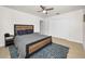 Well-lit bedroom with a modern bed frame, ceiling fan, and ample closet space at 1620 Sea Breeze Dr, Tarpon Springs, FL 34689
