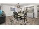 Dining area open to the kitchen boasts a stylish table and contemporary lighting at 1620 Sea Breeze Dr, Tarpon Springs, FL 34689