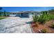 Charming home with a well-manicured lawn, gray exterior, and spacious driveway at 1620 Sea Breeze Dr, Tarpon Springs, FL 34689