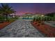 Beautifully landscaped home with an elegant paved driveway and manicured shrubs at 1620 Sea Breeze Dr, Tarpon Springs, FL 34689