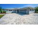 Home featuring a large driveway and a spacious two-car garage at 1620 Sea Breeze Dr, Tarpon Springs, FL 34689