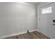 Bright foyer featuring a stylish front door, wood-look floors, and fresh paint at 1620 Sea Breeze Dr, Tarpon Springs, FL 34689