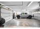 Spacious garage featuring parking space for truck, three doors and overhead storage at 1620 Sea Breeze Dr, Tarpon Springs, FL 34689