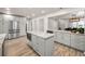 Well-lit kitchen with stainless steel appliances, marble countertops and wood floors at 1620 Sea Breeze Dr, Tarpon Springs, FL 34689