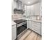Modern kitchen boasts stainless steel range hood and marble countertops at 1620 Sea Breeze Dr, Tarpon Springs, FL 34689
