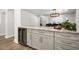 Kitchen with marble countertops, wine cooler, ample cabinet space, and adjacent dining area at 1620 Sea Breeze Dr, Tarpon Springs, FL 34689