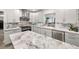 Bright kitchen featuring marble countertops, stainless steel appliances and white cabinetry at 1620 Sea Breeze Dr, Tarpon Springs, FL 34689
