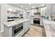 Bright, open kitchen features marble countertops, stainless steel appliances and modern cabinetry at 1620 Sea Breeze Dr, Tarpon Springs, FL 34689