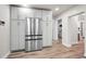 Stainless steel refrigerator with matching cabinets and light wood floor at 1620 Sea Breeze Dr, Tarpon Springs, FL 34689