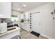 Laundry room with modern washer and dryer, storage, and outside access at 1620 Sea Breeze Dr, Tarpon Springs, FL 34689