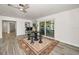 Open-concept living room with wood floors, wet bar and view of the backyard at 1620 Sea Breeze Dr, Tarpon Springs, FL 34689