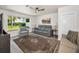 Cozy living room with a gray sofa, chair, and a window view of the outside area at 1620 Sea Breeze Dr, Tarpon Springs, FL 34689