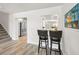 Living room area with wood floors and breakfast bar with seating at 1620 Sea Breeze Dr, Tarpon Springs, FL 34689