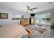 Large main bedroom offering water views, wood-look floors, and a ceiling fan at 1620 Sea Breeze Dr, Tarpon Springs, FL 34689
