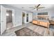 Spacious main bedroom features wood-look flooring, ceiling fan and ensuite bathroom entrance at 1620 Sea Breeze Dr, Tarpon Springs, FL 34689
