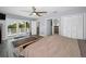 Light-filled main bedroom with ensuite bathroom, balcony access and wood-look flooring at 1620 Sea Breeze Dr, Tarpon Springs, FL 34689