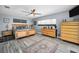 Bright main bedroom with wood-look floors, a ceiling fan, and ample natural light at 1620 Sea Breeze Dr, Tarpon Springs, FL 34689