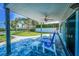 Back patio has chairs and a ceiling fan with an amazing water view at 1620 Sea Breeze Dr, Tarpon Springs, FL 34689