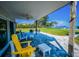 Back patio with chairs and a ceiling fan with an amazing water view at 1620 Sea Breeze Dr, Tarpon Springs, FL 34689