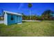 Exterior view of backyard shed with well maintained lawn and mature foliage at 1620 Sea Breeze Dr, Tarpon Springs, FL 34689