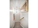 View of the staircase with neutral carpeting, handrail, and decorative lighting at 1620 Sea Breeze Dr, Tarpon Springs, FL 34689