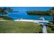 Waterfront property with a grassy lawn, dock, and picturesque water views at 1620 Sea Breeze Dr, Tarpon Springs, FL 34689