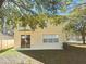 Two-story home featuring a sliding glass door and an expansive yard with trees at 19551 Timberbluff Dr, Land O Lakes, FL 34638