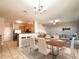 Open-concept dining and kitchen area featuring updated appliances and bar seating at 19551 Timberbluff Dr, Land O Lakes, FL 34638