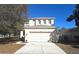 Two-story home with a two-car garage and a well-manicured lawn with trees at 19551 Timberbluff Dr, Land O Lakes, FL 34638