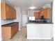 An open kitchen featuring wood cabinets, stainless steel appliances, and tile flooring at 19551 Timberbluff Dr, Land O Lakes, FL 34638