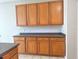 Close up view of wood cabinetry and countertop in kitchen at 19551 Timberbluff Dr, Land O Lakes, FL 34638