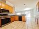 Kitchen featuring wood cabinets, stainless steel appliances, and tile flooring at 19551 Timberbluff Dr, Land O Lakes, FL 34638