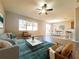 Bright living room featuring modern furnishings, ceiling fan and access to the dining area at 19551 Timberbluff Dr, Land O Lakes, FL 34638