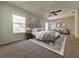 Bright main bedroom featuring a ceiling fan, decorative pillows, and a cozy sitting area at 19551 Timberbluff Dr, Land O Lakes, FL 34638