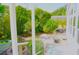 View of the backyard with patio and lush greenery from a covered porch area at 20960 Little Magens Loop, Lutz, FL 33558