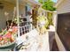 Charming home exterior with covered porch, flower pots, and mature plants alongside at 20960 Little Magens Loop, Lutz, FL 33558