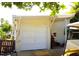 Exterior view of the garage displaying its white door, house number, and golf cart, adding convenience and curb appeal at 20960 Little Magens Loop, Lutz, FL 33558