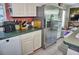 This is a kitchen with a stainless steel refrigerator and white cabinets at 20960 Little Magens Loop, Lutz, FL 33558