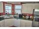 Charming kitchen featuring a corner sink and white cabinets at 20960 Little Magens Loop, Lutz, FL 33558