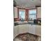 Charming kitchen featuring a corner sink and white cabinets at 20960 Little Magens Loop, Lutz, FL 33558