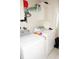Bright laundry room featuring a white washer and dryer set and overhead storage at 20960 Little Magens Loop, Lutz, FL 33558