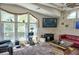Inviting living room featuring large windows, vaulted ceilings, a TV, red sofa, and plush carpeting for comfortable living at 20960 Little Magens Loop, Lutz, FL 33558