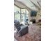 Spacious living room with large windows and a comfortable recliner at 20960 Little Magens Loop, Lutz, FL 33558
