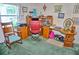 A home office with wood furniture and a comfortable red chair at 20960 Little Magens Loop, Lutz, FL 33558