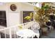 Comfortable patio area with white metal furniture and mature plants and trees at 20960 Little Magens Loop, Lutz, FL 33558
