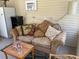 Relaxing sunroom featuring a cozy sofa and ample natural light from windows at 20960 Little Magens Loop, Lutz, FL 33558