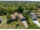 Aerial view of home surrounded by mature trees, lush greenery, and neighborhood landscape at 2443 Glenridge Dr, Spring Hill, FL 34609