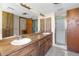 Bathroom with a double sink vanity, cabinets, and a glass-enclosed shower at 2443 Glenridge Dr, Spring Hill, FL 34609