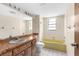 Bathroom with a single sink vanity, yellow bathtub, and tile flooring at 2443 Glenridge Dr, Spring Hill, FL 34609