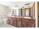 Bathroom features a double sink vanity with a wooden finish and tiled flooring at 2443 Glenridge Dr, Spring Hill, FL 34609